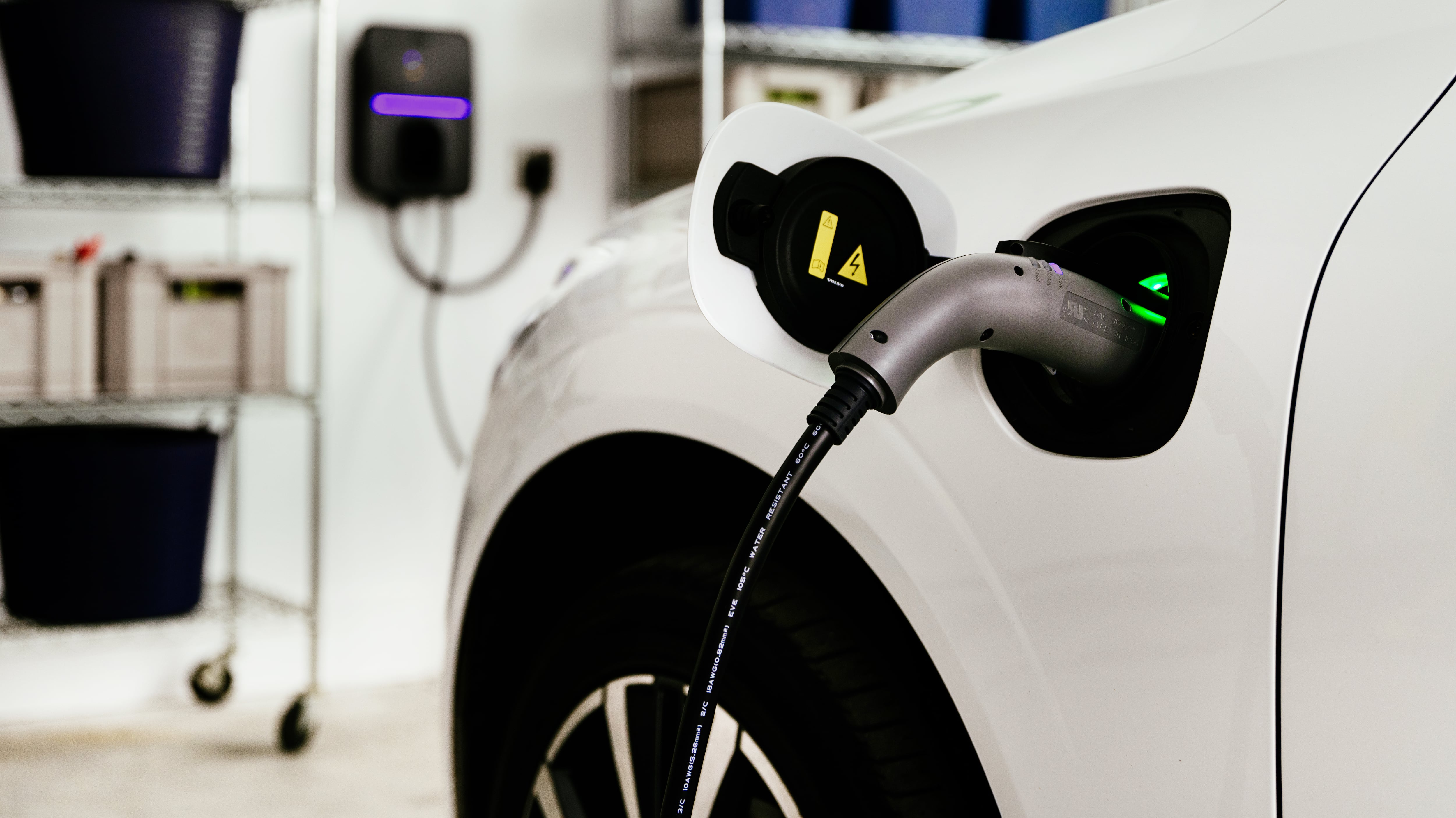 Electric vehicle charges in residential garage